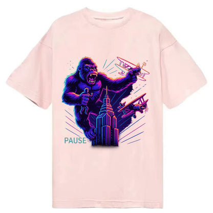 giant gorilla on top of skyscraper holding small figure, swatting planes - Classic T-shirt - Pink