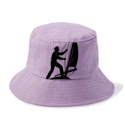 Sailor adjusting the boom on a sailboat - Bucket Hat - Purple
