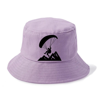 Paraglider soaring over mountain peaks - Bucket Hat - Purple