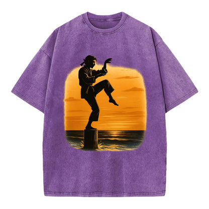 karate crane kick pose on wooden post at beach sunset - Vintage T-shirt - Purple