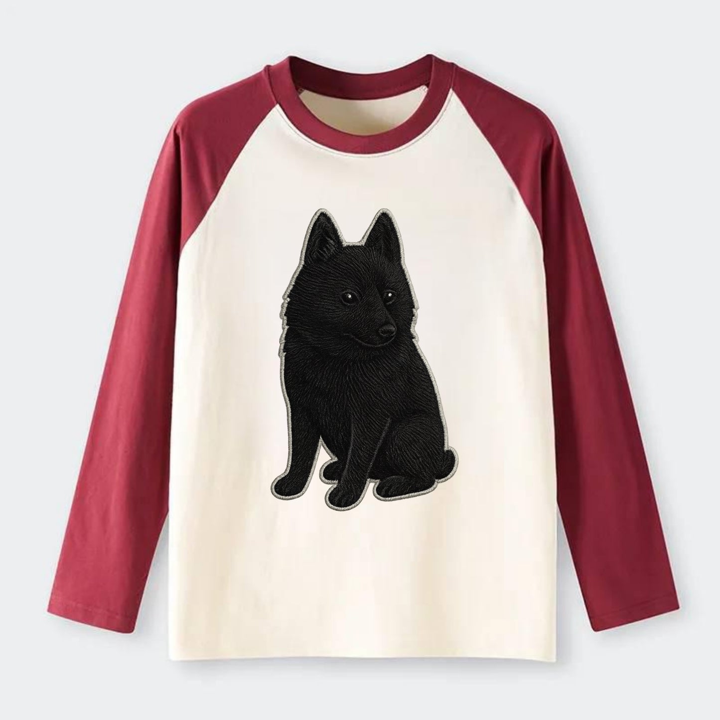 Schipperke - Solid black small embroidered sitting pose - Raglan Long Sleeve T-Shirt - Red
