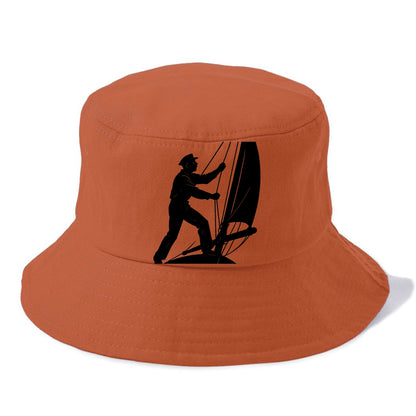 Sailor adjusting the boom on a sailboat - Bucket Hat - Red
