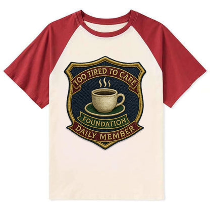Crest with coffee cup - "Too Tired To Care Foundation - Daily Member" - - Contrast Raglan T-shirt - Red