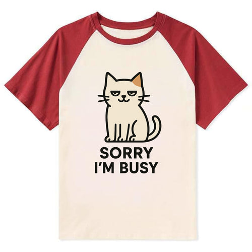 Cat sitting alone looking content - SORRY I'M BUSY - not sorry at all - Contrast Raglan T-shirt