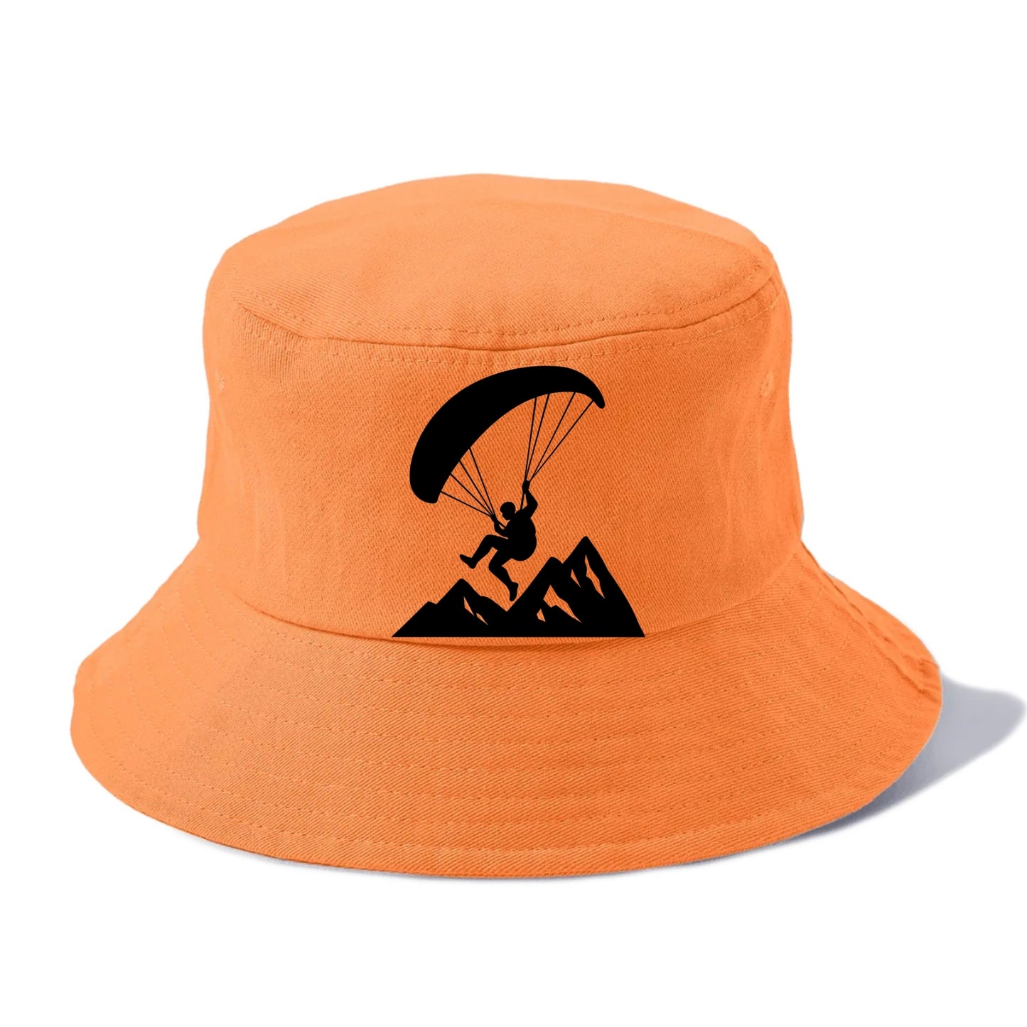 Paraglider soaring over mountain peaks - Bucket Hat - Terracotta Clay(Orange)