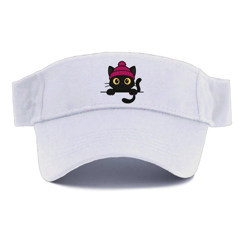 Midnight the black cat holding a tiny book labeled secrets against the ledge. - Visor