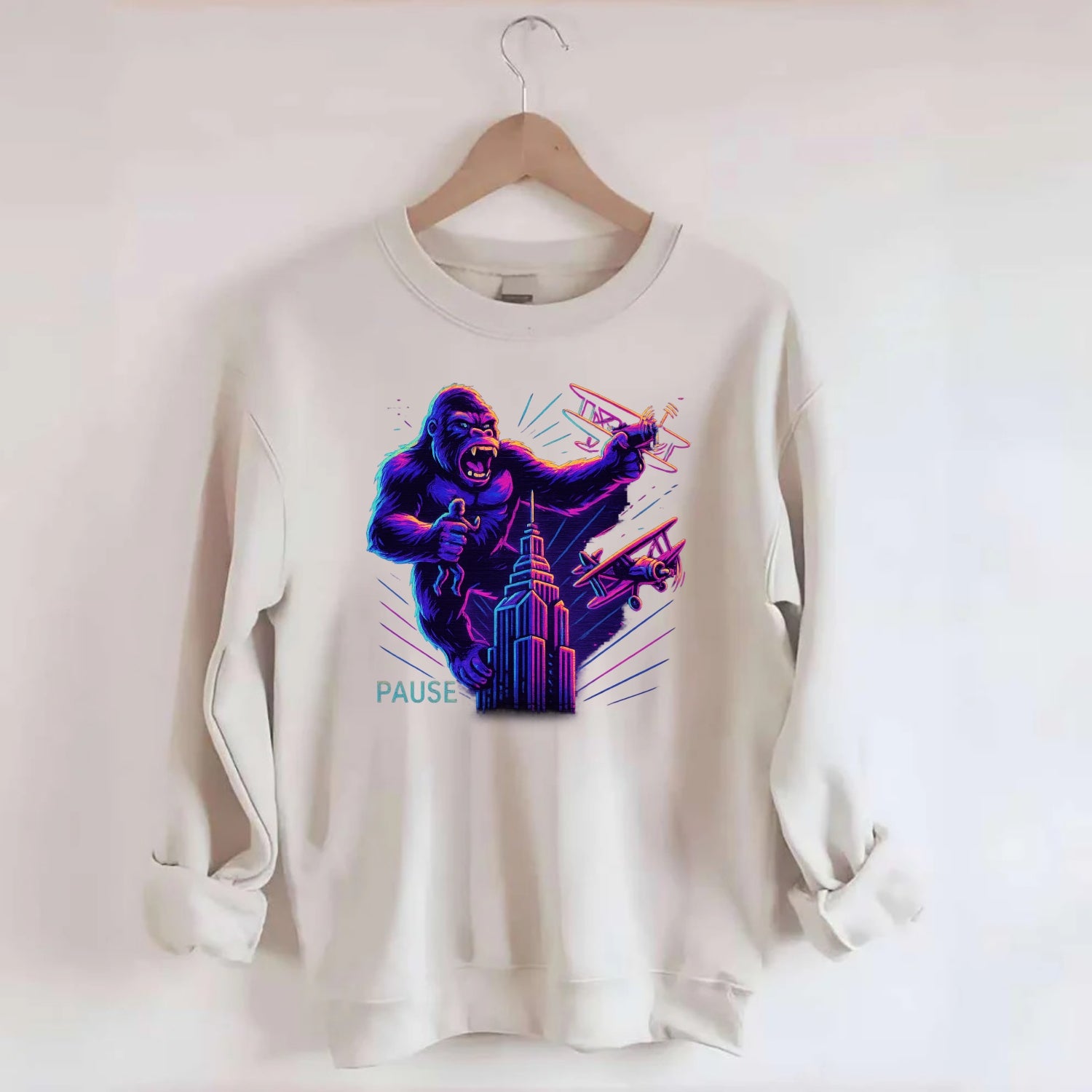 giant gorilla on top of skyscraper holding small figure, swatting planes - Crewneck Sweatshirt - biege
