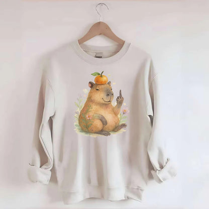 chonky capybara relaxing with orange on head, one webbed middle finger up - Crewneck Sweatshirt - biege