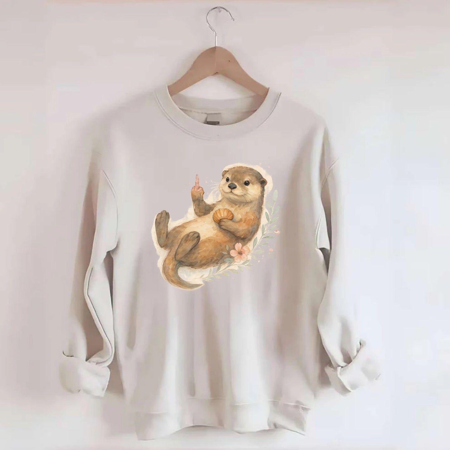 adorable otter floating on back, middle finger up while holding a shellfish - Crewneck Sweatshirt - biege