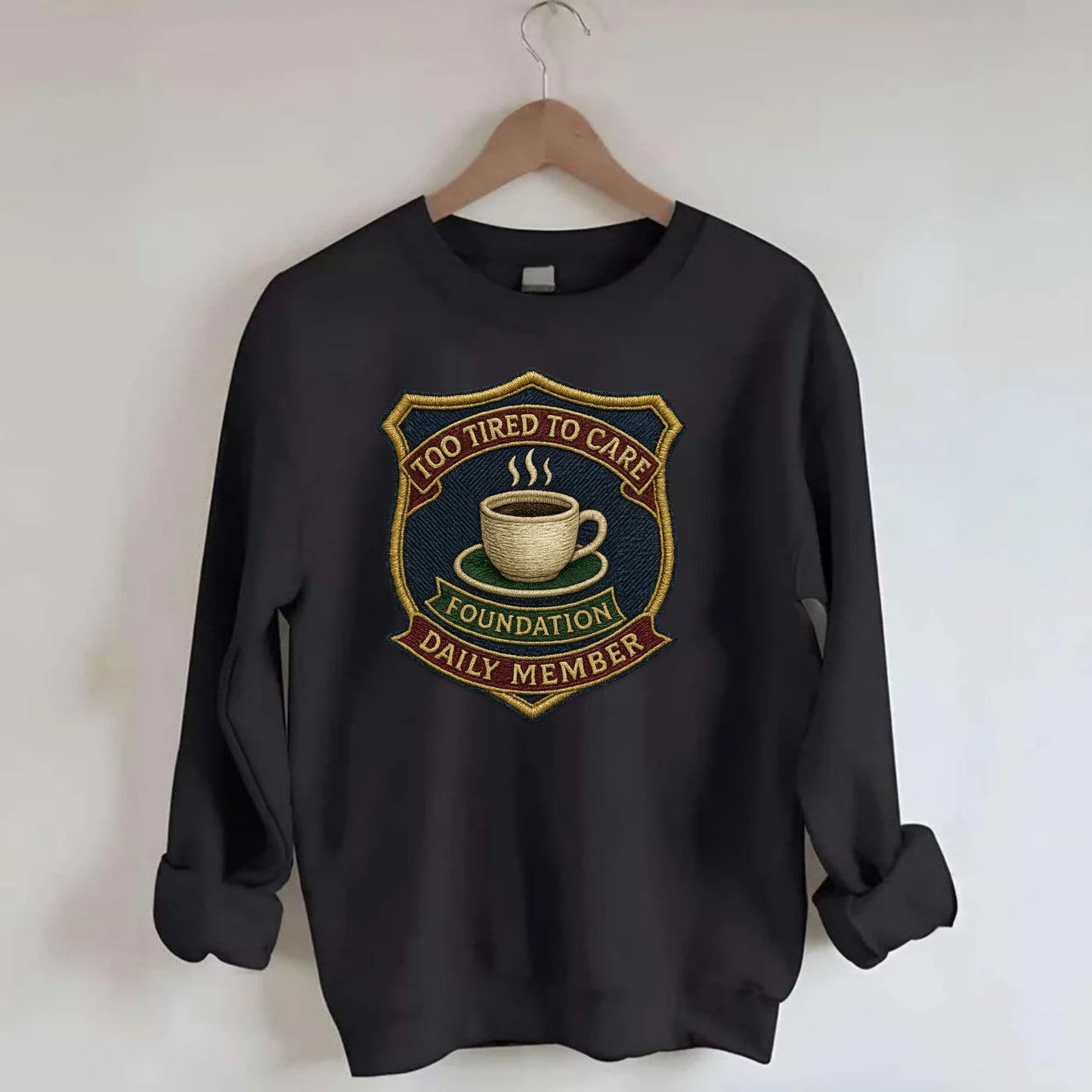 Crest with coffee cup - "Too Tired To Care Foundation - Daily Member" - - Crewneck Sweatshirt - black