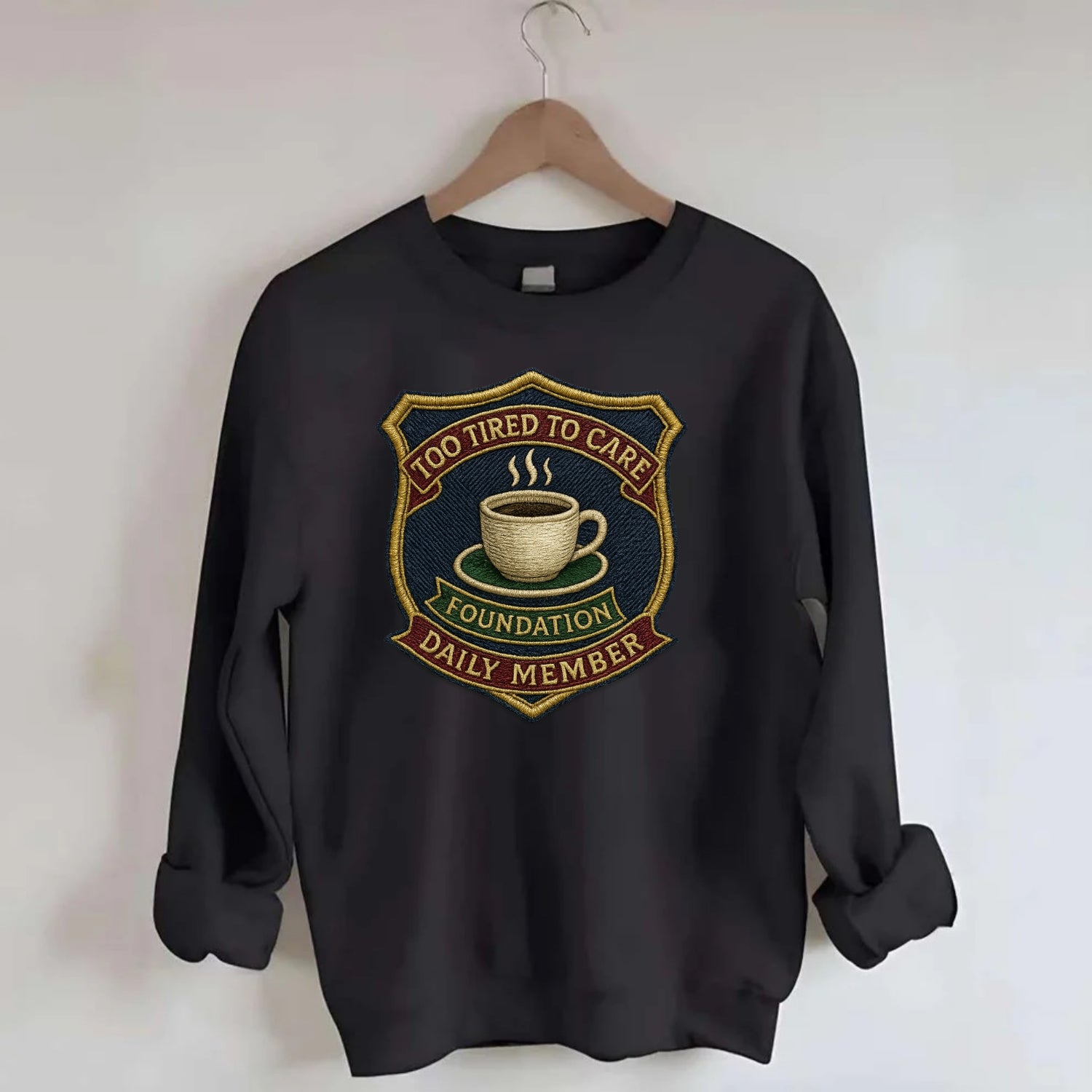 Crest with coffee cup - "Too Tired To Care Foundation - Daily Member" - - Crewneck Sweatshirt - black