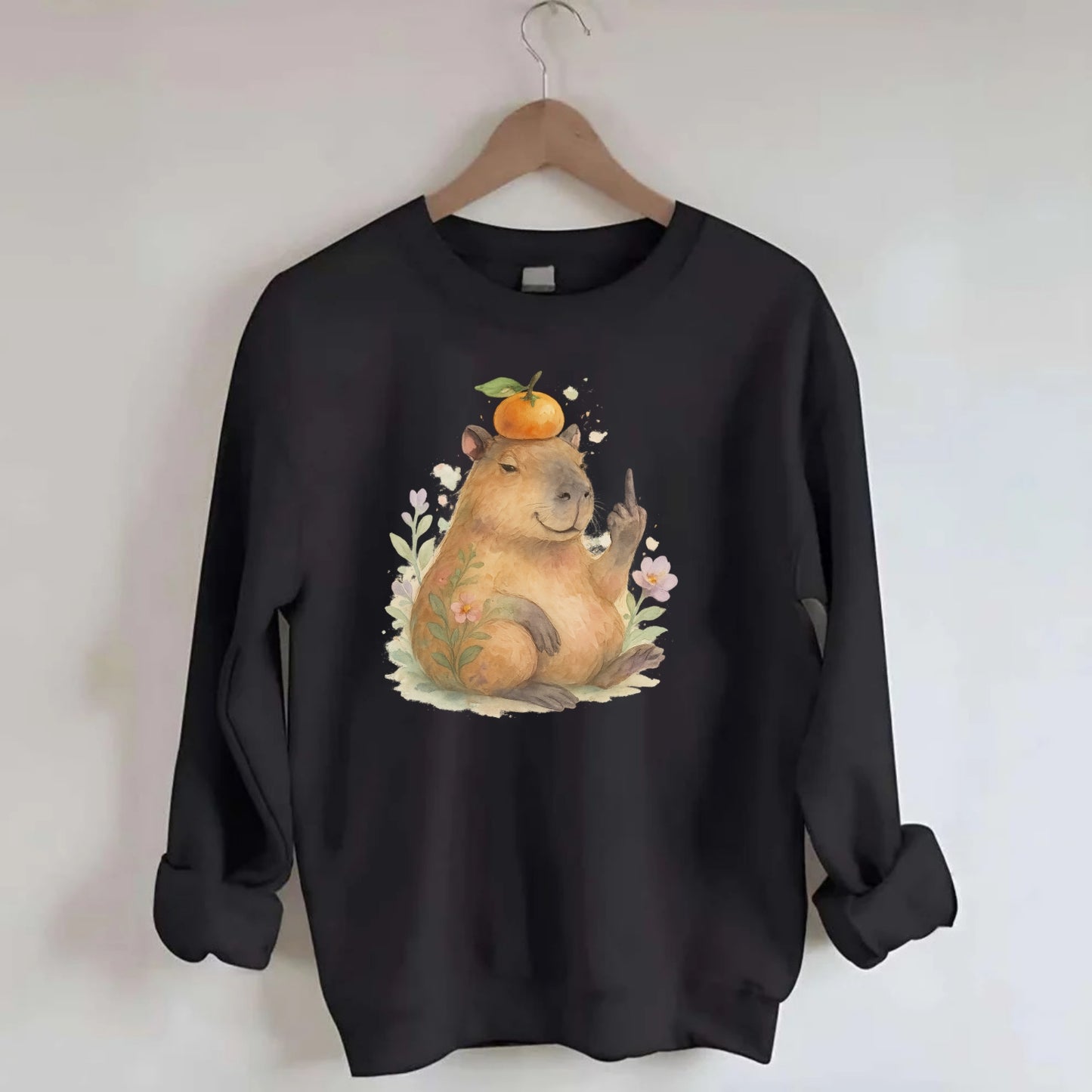 chonky capybara relaxing with orange on head, one webbed middle finger up - Crewneck Sweatshirt - black