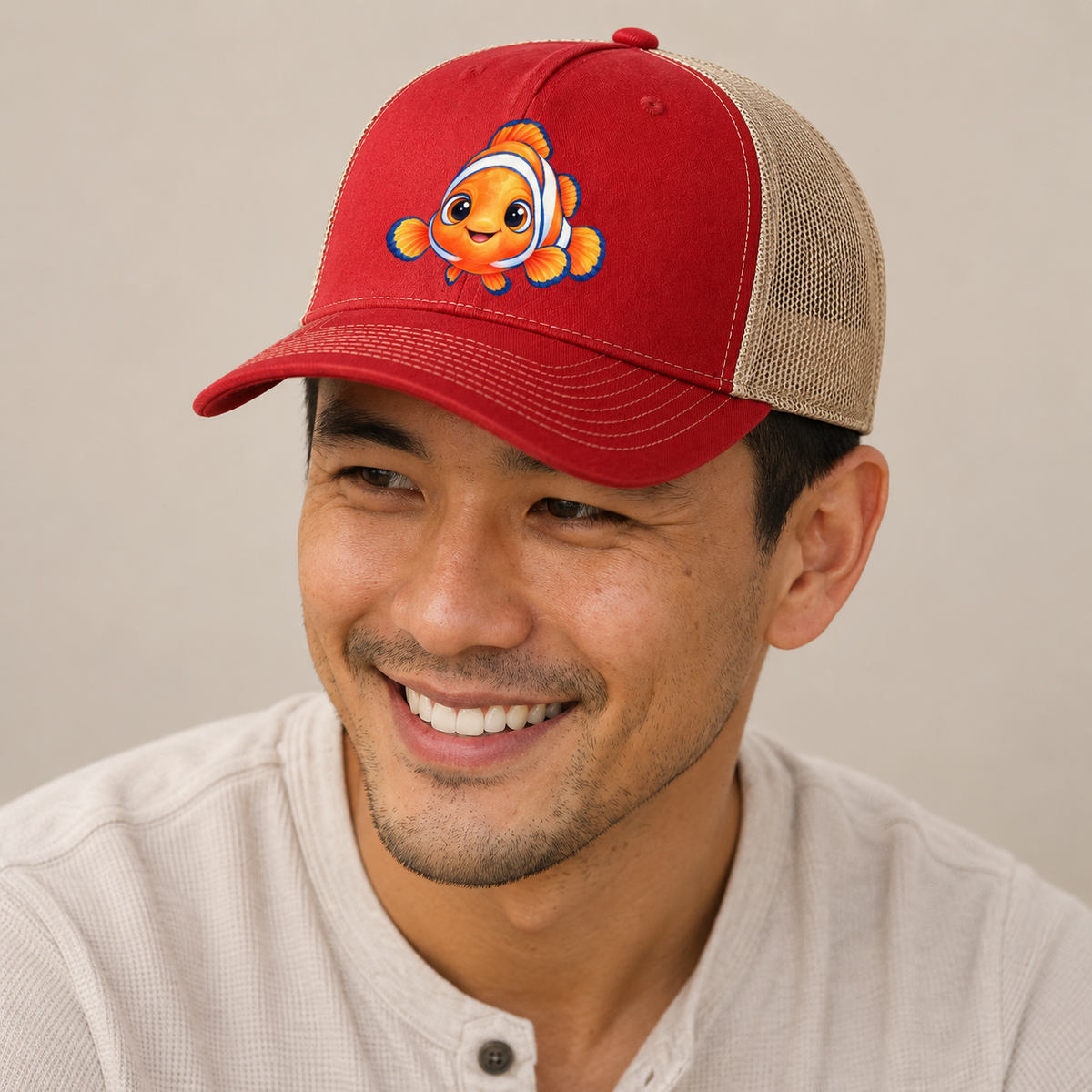 Clownfish Symmetric Hello Sea Sprite Trucker Hat — studio model wearing the hat