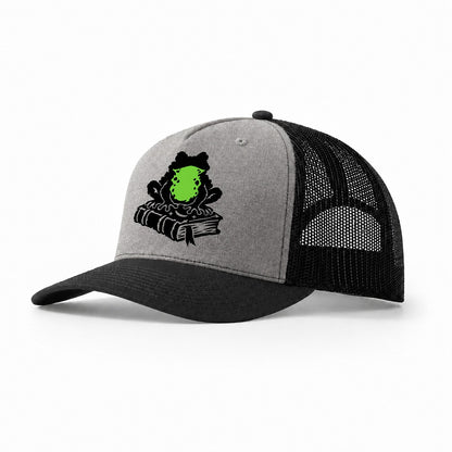 Familiar Toad On A Spellbook Witch Magic Trucker Hat – Grey Black