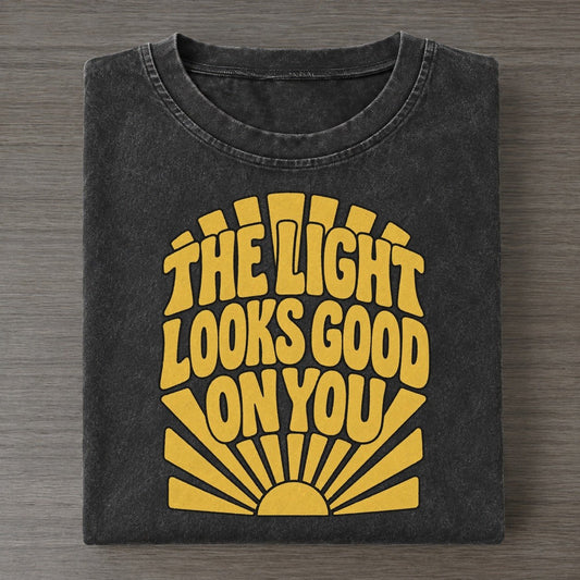 The Light Looks Good On You Sunburst Sayings Vintage T-shirt – Black