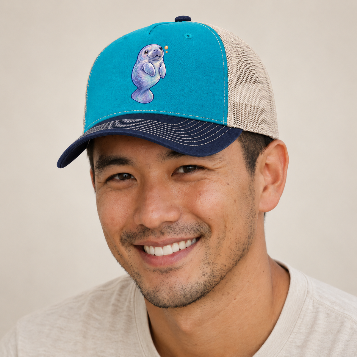 Manatee Upward Float Sea Sprite Trucker Hat — studio model wearing the hat