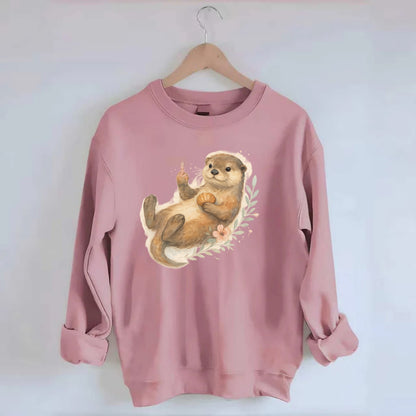 adorable otter floating on back, middle finger up while holding a shellfish - Crewneck Sweatshirt - pink