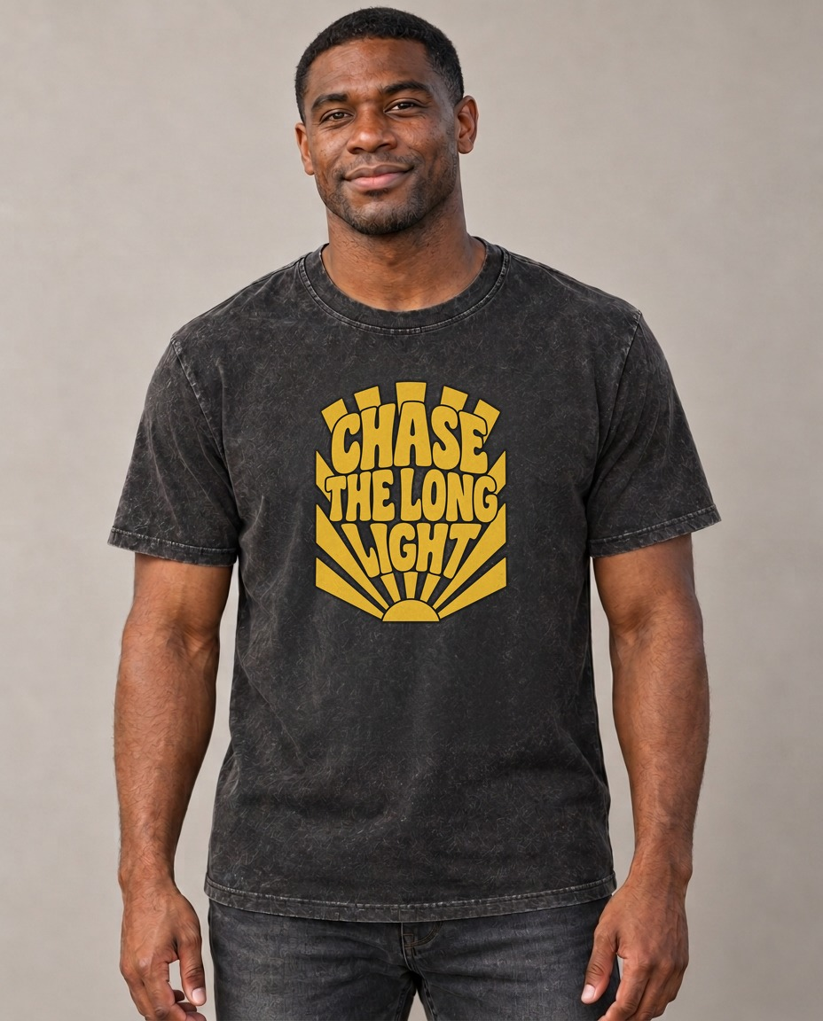 Chase The Long Light Sunburst Sayings Vintage T-shirt – black, small print on model (AI mockup)