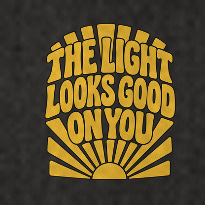 The Light Looks Good On You Sunburst Sayings Vintage T-shirt – black, print and cotton detail (AI mockup)