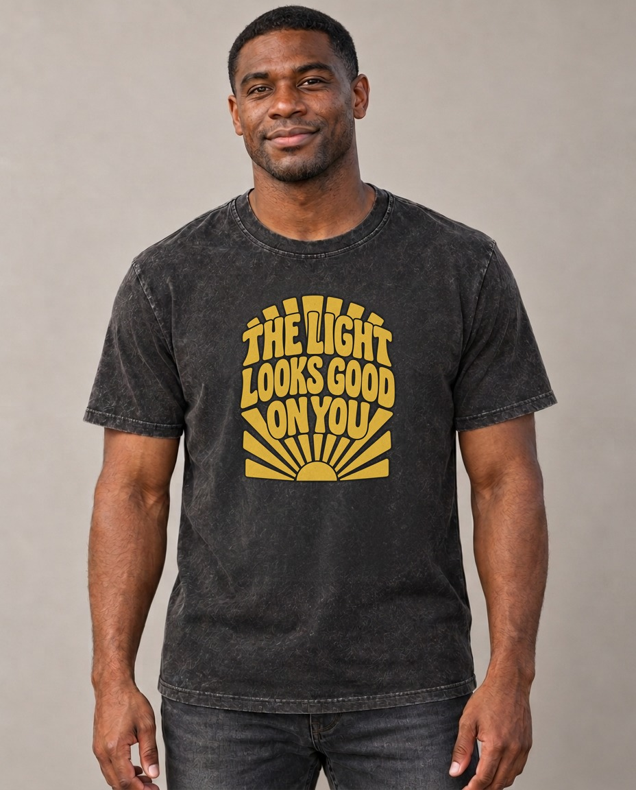 The Light Looks Good On You Sunburst Sayings Vintage T-shirt – black, small print on model (AI mockup)