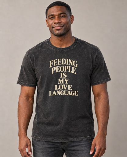 Feeding People Is My Love Language Quiet Statements Vintage T-shirt – black, small print on model (AI mockup)