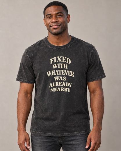 Fixed With Whatever Was Already Nearby Quiet Statements Vintage T-shirt – black, small print on model (AI mockup)