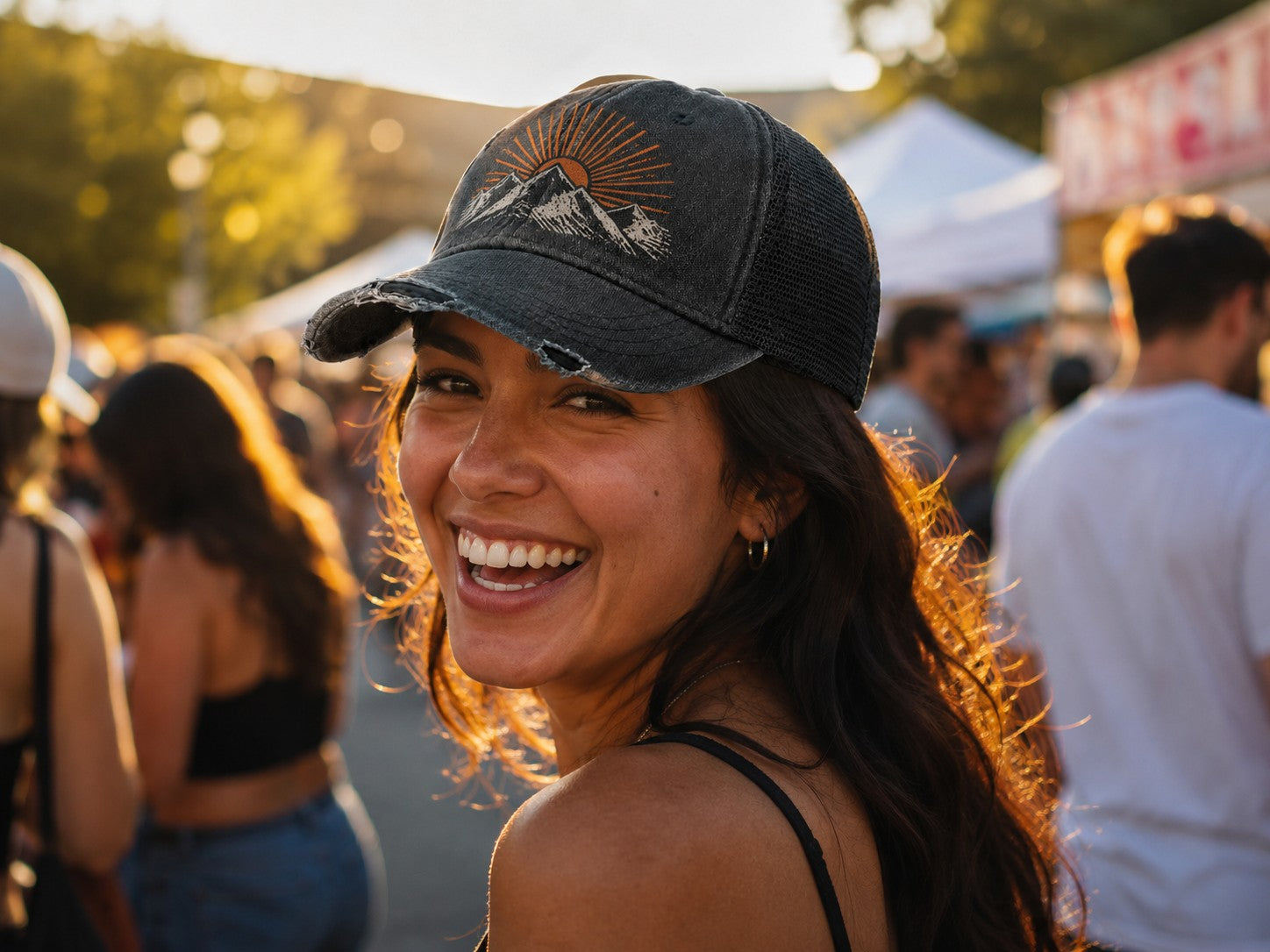 Washed trucker hat with printed sunburst mountain design at a summer market
