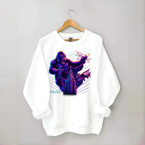 giant gorilla on top of skyscraper holding small figure, swatting planes - Crewneck Sweatshirt