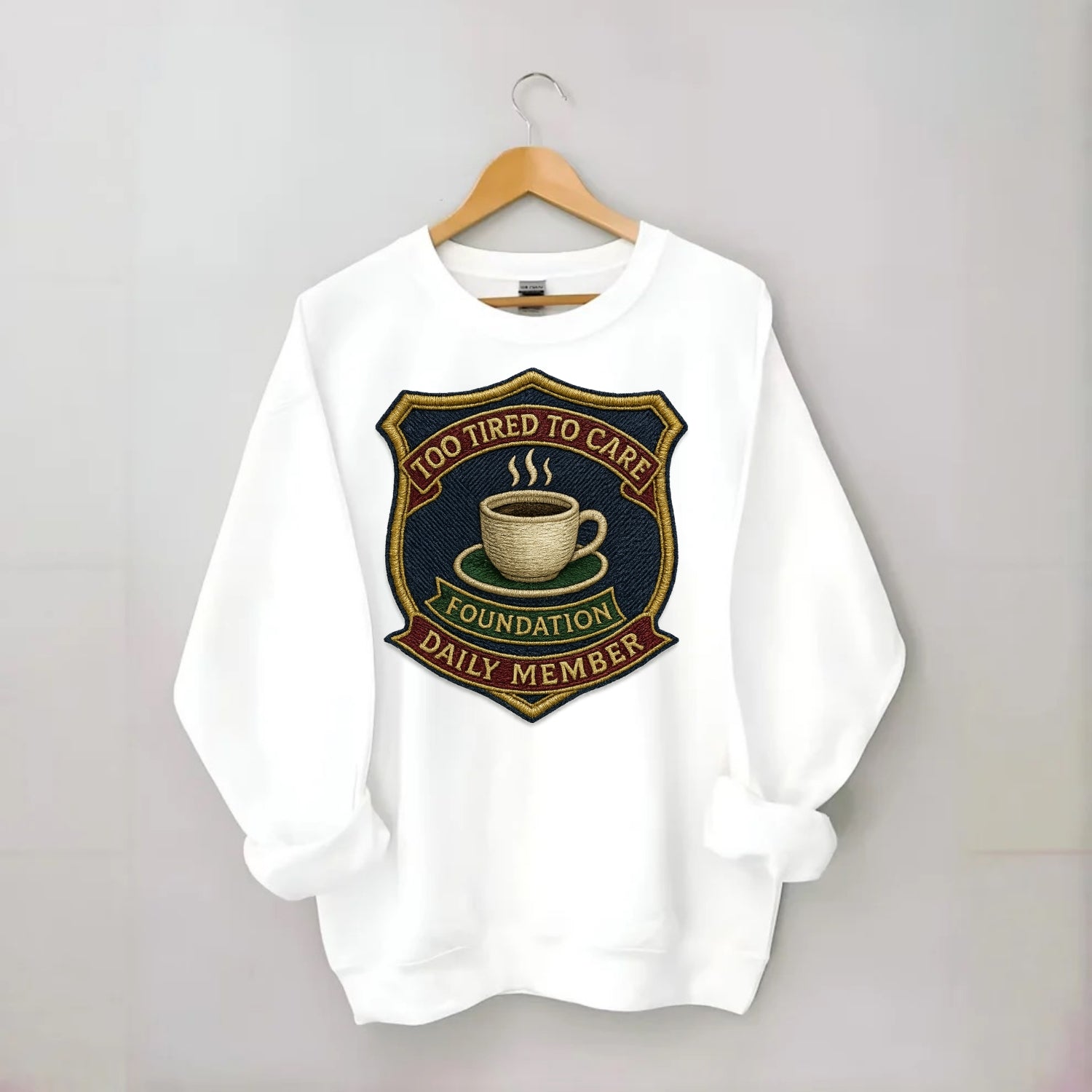 Crest with coffee cup - "Too Tired To Care Foundation - Daily Member" - - Crewneck Sweatshirt - white