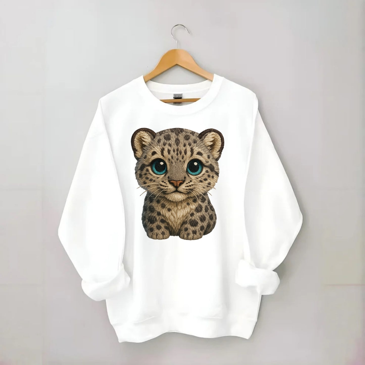 Baby Snow Leopard Cub - gray spotted, thick fur, blue-green eyes, - Crewneck Sweatshirt - white