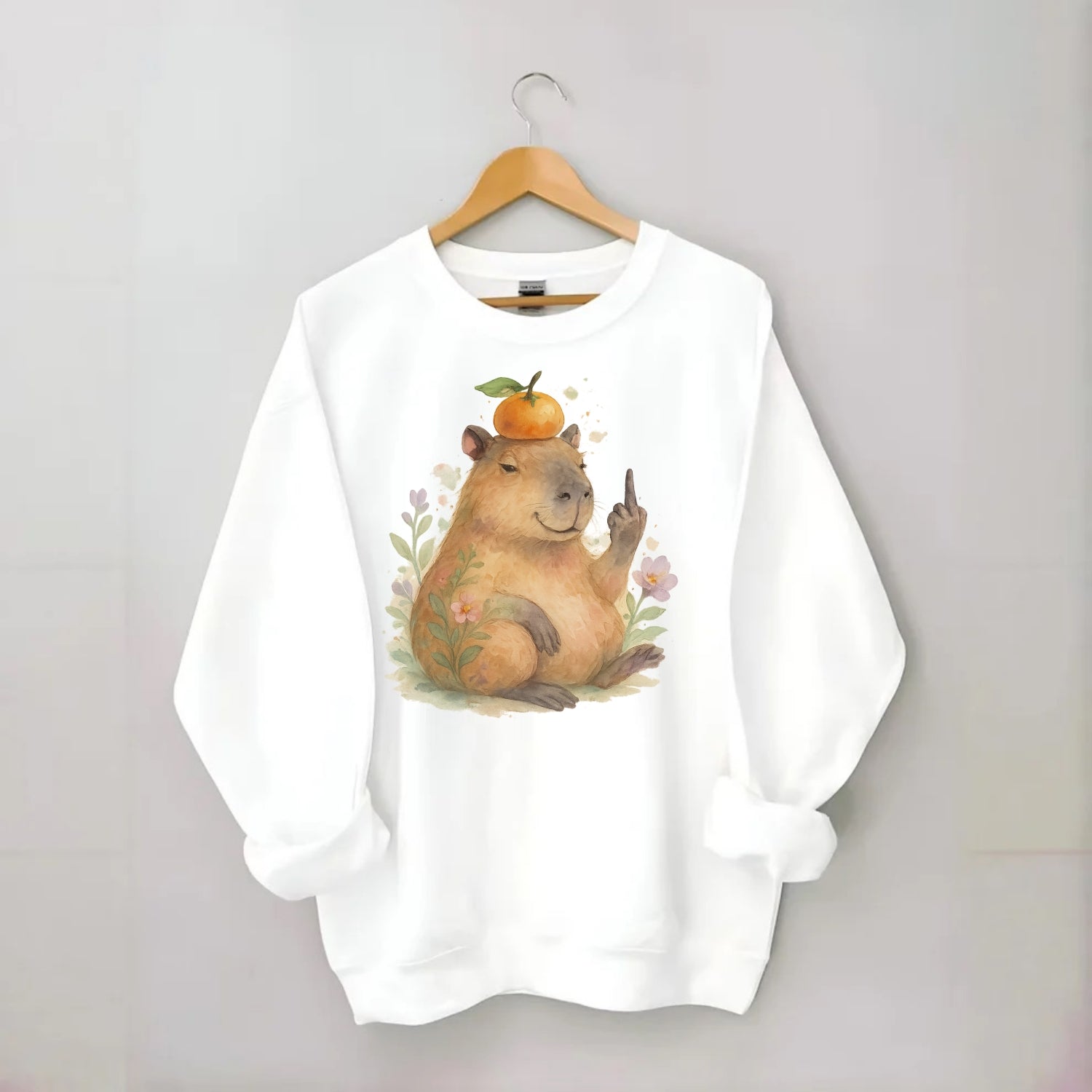 chonky capybara relaxing with orange on head, one webbed middle finger up - Crewneck Sweatshirt - white